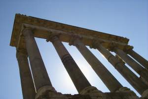 Ruined columns in the Forum silhouetted against a perfect Rome sky