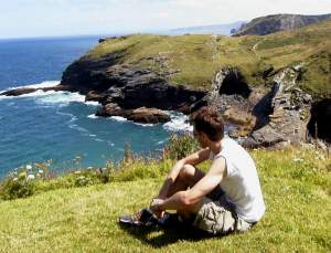 Looking out on the rugged coastline. You can see one of the largest caves just above my head.