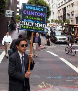 Took this photo this morning on the way to work. I see this guy frequently during my
walk to work and I have no idea what he means by his very strange sign!
