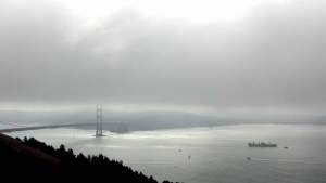 I took them on my favorite drive over to the Marin Headlands. There, however,
the fog still lay thickly, hiding most of the views. But you can still make out the World
War II liberty ship, the Jeremiah O'Brien, steaming towards the Golden Gate Bridge.